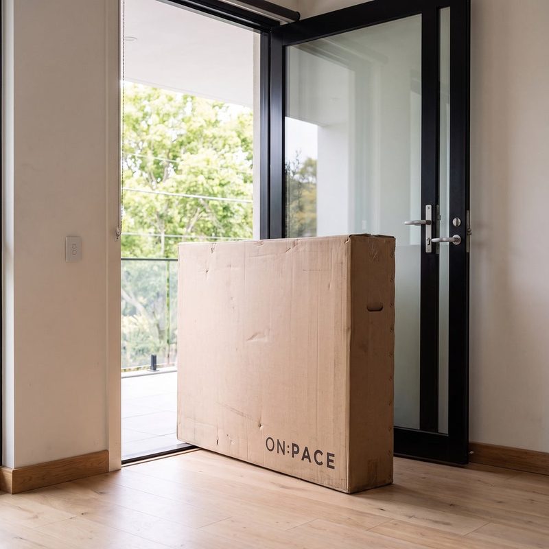 A boxed ON:PACE treadmill